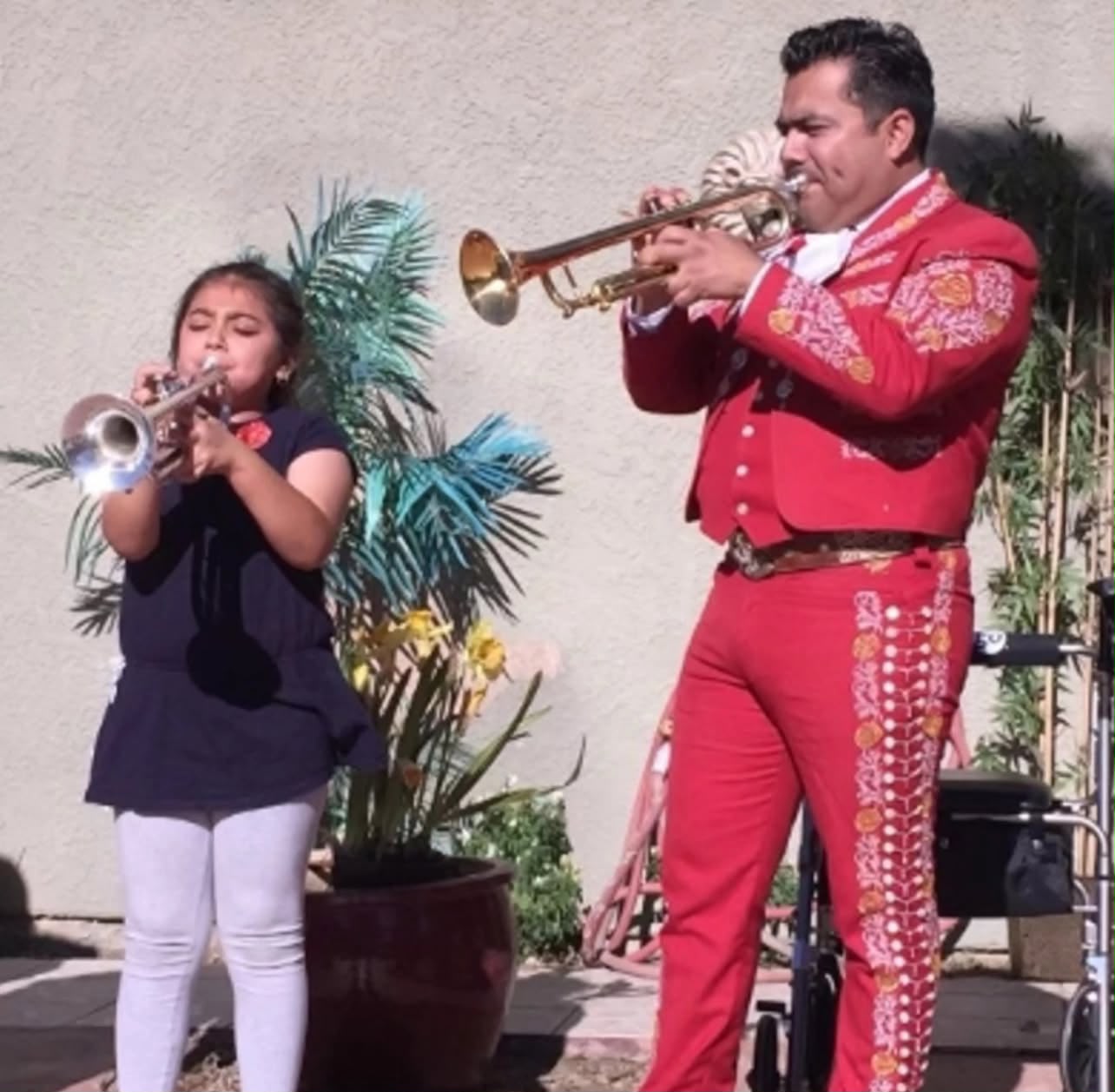 Father and daughter playing trumpet together